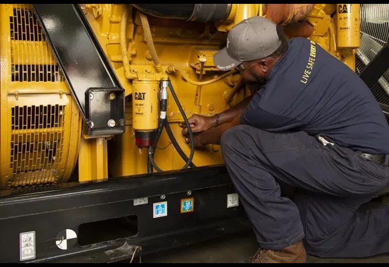 Technician servicing a heavy-duty industrial CAT generator in Abuja